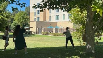 Sarah Driver holds the fate of cow piñata in her hands.