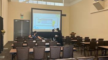 AGS 2023 committee members prepare the space for a session.